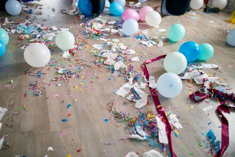 Top view of floor with after a party celebration with empty blue bottles